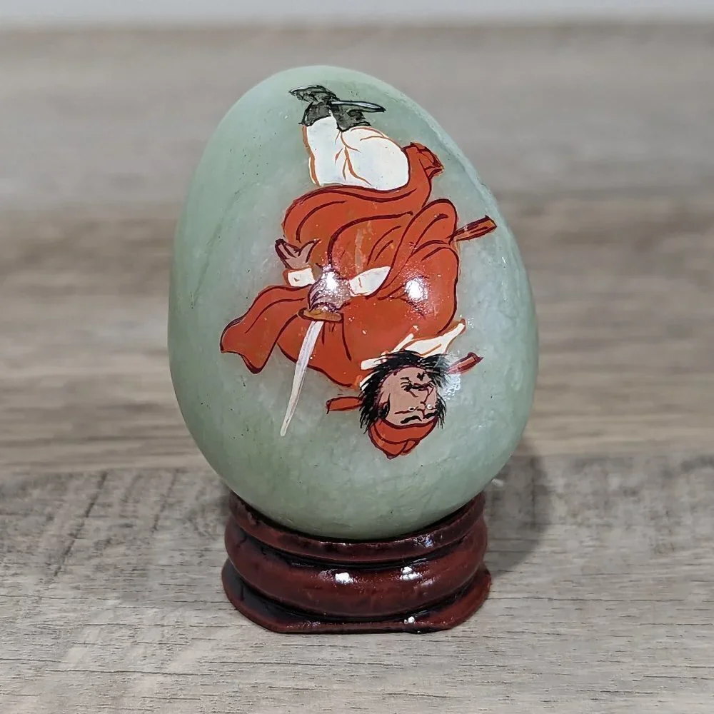 Hand carved natural green jade egg with Zhong Kui with wooden stand